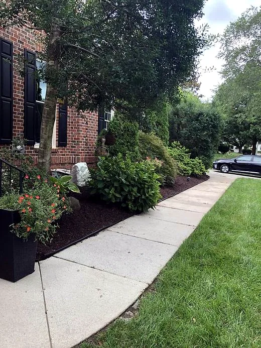 Clean, edged walkway bed with fresh mulch after service